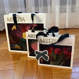Aritzia White Floral Gift Bags with Black Ribbon Handles